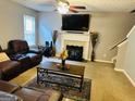 Comfortable living room with a fireplace, ceiling fan, and a large, plush leather sectional at 789 Winbrook Dr # 1, Mcdonough, GA 30253