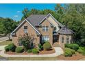 Beautiful two-story brick home with well-maintained landscaping and a welcoming walkway at 1500 Royce Dr, Locust Grove, GA 30248