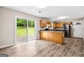 Open kitchen with wood cabinets and sliding doors to a spacious backyard at 5724 Amalfi Way, Douglasville, GA 30135