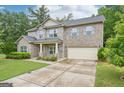 Attractive two-story brick house with a well-kept lawn and an attached two-car garage at 12323 Styron Dr, Hampton, GA 30228