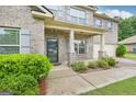 Welcoming front porch with brick columns and manicured landscaping enhancing the home's curb appeal at 12323 Styron Dr, Hampton, GA 30228