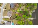 Aerial view showcasing a generous waterfront lot with mature trees and privacy at 157 Waterlace Way, Fayetteville, GA 30215