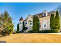 Elegant brick home showcasing mature trees and manicured landscaping on a sprawling green lawn at 1214 Greenridge Ln, Lithonia, GA 30058