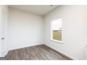 Bright bedroom with a window and wood-look flooring at 243 Oliver Dr, Locust Grove, GA 30248