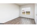 Bright bedroom with a large window and wood-look flooring at 243 Oliver Dr, Locust Grove, GA 30248