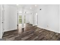 A bright living area is enhanced by dark gray wood floors and natural light at 3232 Abbeywood Dr, Decatur, GA 30034