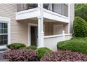 Ground floor patio of a condo with neat, surrounding greenery and picket fence at 1017 Ridgefield Dr, Peachtree City, GA 30269