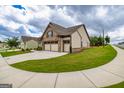 Attractive single-Gathering home boasting green lawn, tidy foliage, and a functional three-car garage at 209 Cottonwood Cir, Peachtree City, GA 30269
