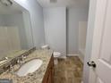 Clean bathroom featuring a vanity with granite countertops, modern fixtures, and a shower/tub combo at 7290 Grayson Dr, Riverdale, GA 30296