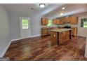 Well-lit kitchen boasts stainless steel appliances, granite countertops, island, and access to a door to the exterior at 7290 Grayson Dr, Riverdale, GA 30296