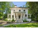 Charming two-story home features classic white columns and manicured landscaping enhancing its curb appeal at 818 Springdale Ne Rd, Atlanta, GA 30306