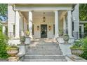 Inviting front porch with grand columns and decorative planters leading to the home's entrance at 818 Springdale Ne Rd, Atlanta, GA 30306