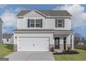 Charming two-story home with a two-car garage and a well-maintained lawn at 455 Prescott Way, Villa Rica, GA 30180