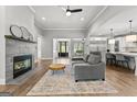 Spacious living room with a modern fireplace, open floor plan, and seamless flow into the kitchen area at 180 Lapis Lake Pt, Fayetteville, GA 30215