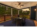 Inviting porch with comfortable seating, ceiling fan, and scenic wooded view, perfect for relaxation and outdoor enjoyment at 180 Lapis Lake Pt, Fayetteville, GA 30215