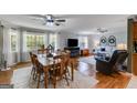 Open living space with hardwood floors, a dining area, and large windows at 75 Barber Rd, Carrollton, GA 30116