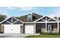 Charming single-story home with brick and siding, featuring a three-car garage and well-manicured lawn at 100 Grande Bishop Dr, Fairburn, GA 30213