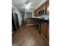 Modern kitchen with stainless steel appliances and wood cabinets at 6420 Pinebark Way, Morrow, GA 30260