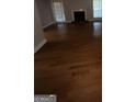 Open living room with hardwood floors and a cozy fireplace at 6420 Pinebark Way, Morrow, GA 30260