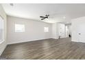 Expansive living room with hardwood floors, a ceiling fan, and abundant natural light from the windows at 488 Cantrell Drive, Dallas, GA 30157