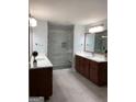 Bathroom with double vanity, wood cabinets, and frameless glass shower at 2321 Norbury Se Cv, Smyrna, GA 30080