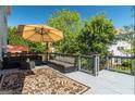 Outdoor patio with comfortable seating, large umbrella, and decorative outdoor rug at 2321 Norbury Se Cv, Smyrna, GA 30080