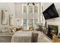 Bright and spacious living room with large windows, vaulted ceilings, fireplace and neutral decor at 1444 Gates Se Cir, Atlanta, GA 30316