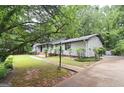 Single-story home featuring a long walkway and a well-maintained lawn at 1590 Colonial South Sw Dr, Conyers, GA 30094