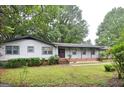 Attractive single-story home featuring a covered front porch and brick accents at 1590 Colonial South Sw Dr, Conyers, GA 30094