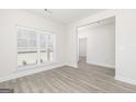 An open-concept living area with wood floors, natural light, and neutral walls at 474 Cantrell Drive, Dallas, GA 30157