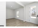 Bright and airy living room with hardwood floors and a large window, leading to backyard at 446 Cantrell Drive, Dallas, GA 30157