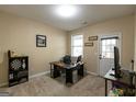 A functional office space features a desk, shelving, and natural light from a window at 6089 Indian Wood Cir, Mableton, GA 30126