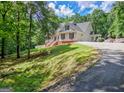 Spacious home with a sprawling driveway and lush green surroundings at 305 Postwood Dr, Fayetteville, GA 30215
