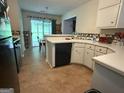 Functional kitchen offering white cabinets and a view into the backyard at 650 Flippen Rd, Stockbridge, GA 30281