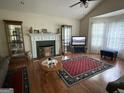 Inviting living room showcasing a fireplace, hardwood floors, and large windows for natural light at 650 Flippen Rd, Stockbridge, GA 30281
