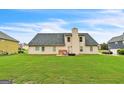 Expansive backyard featuring a well-maintained lawn, perfect for outdoor activities and entertaining, with a traditional home exterior at 115 Glen Echo Dr., Covington, GA 30016
