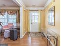 Inviting foyer featuring hardwood floors, neutral walls, and a decorative mirror, creating a warm and welcoming entrance at 115 Glen Echo Dr., Covington, GA 30016