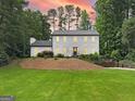 Charming two-story home with bright exterior lighting and a lush green lawn at 2885 Laurel Green Ct, Roswell, GA 30076