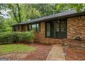 Brick home featuring a covered front porch and beautiful landscaping at 1124 Ponderosa Park Dr, Forest Park, GA 30297