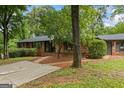 Brick home with mature landscaping, a brick walkway, and a driveway at 1124 Ponderosa Park Dr, Forest Park, GA 30297