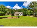 Landscaped front yard featuring a well-maintained lawn and charming exterior at 130 Laurel Lake Rd, Tyrone, GA 30290