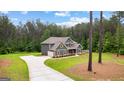 Beautiful two-story home features lush backyard, long driveway, and attached garage at 74 Riverwood Trl, Grantville, GA 30220