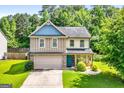 Charming two-story home featuring a well-manicured lawn and a mix of brick and siding accents at 149 Pristine Dr, Locust Grove, GA 30248