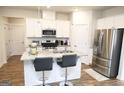 Modern kitchen features granite countertops, stainless steel appliances, and a convenient island with barstool seating at 2845 Long Shadow Ct, Snellville, GA 30078
