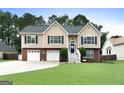 Attractive home exterior with a lush green lawn and a well-maintained front yard at 341 Jodeco Station E Cir, Stockbridge, GA 30281