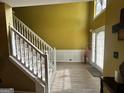 Inviting foyer showcasing a staircase, wood flooring, and bright, natural light at 4466 Estate St, South Fulton, GA 30349