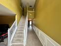 Spacious hallway featuring hardwood floors, staircase and neutral wall colors at 4466 Estate St, South Fulton, GA 30349