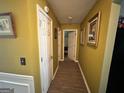Hallway featuring hardwood floors, white doors and neutral wall colors at 4466 Estate St, South Fulton, GA 30349