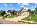 Attractive single-story home with a wide driveway and manicured front lawn at 697 Emporia Loop, Mcdonough, GA 30253