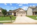 Inviting single-story home featuring a two-car garage and lush green lawn at 697 Emporia Loop, Mcdonough, GA 30253